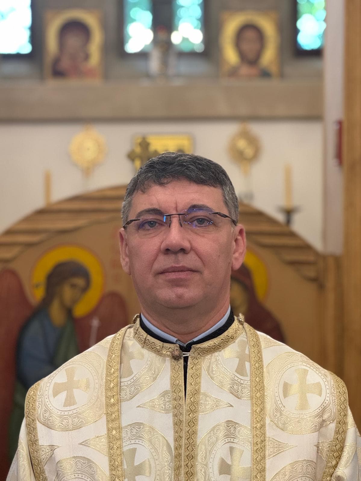 Subdeacon Ion Baragau, vested in cream and gold, before the iconostasis